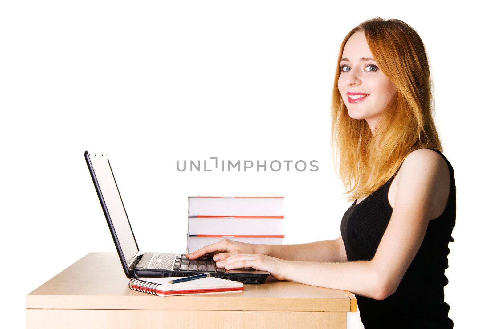 Beautiful young woman working at her laptop, white background