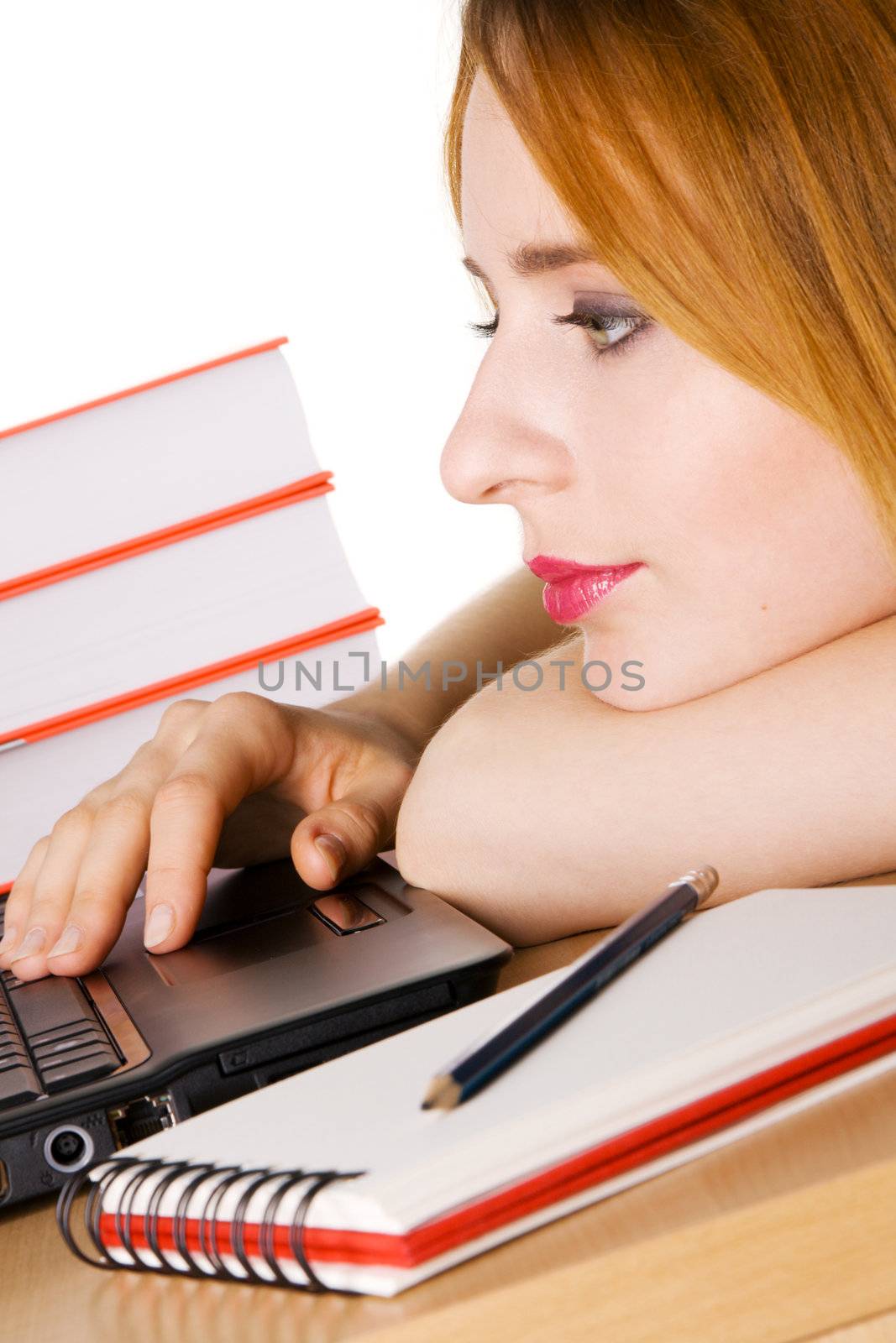 Young girl surfing the internet at her laptop