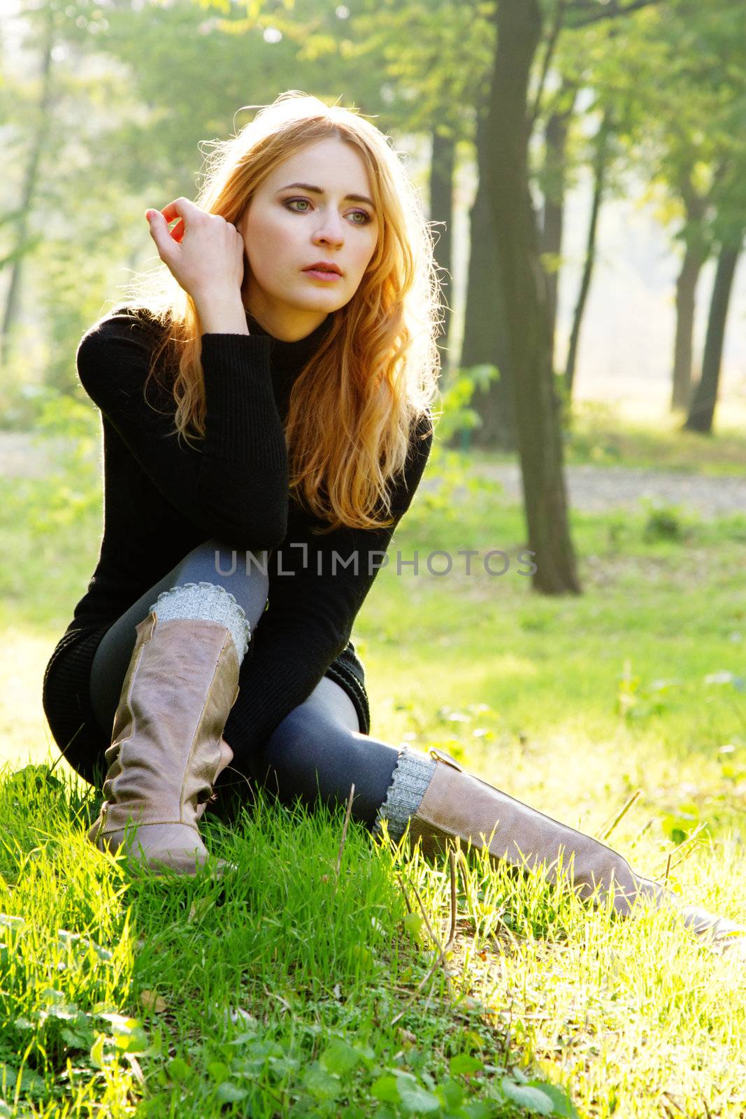 Young beautiful lady in an autumn park by Gdolgikh