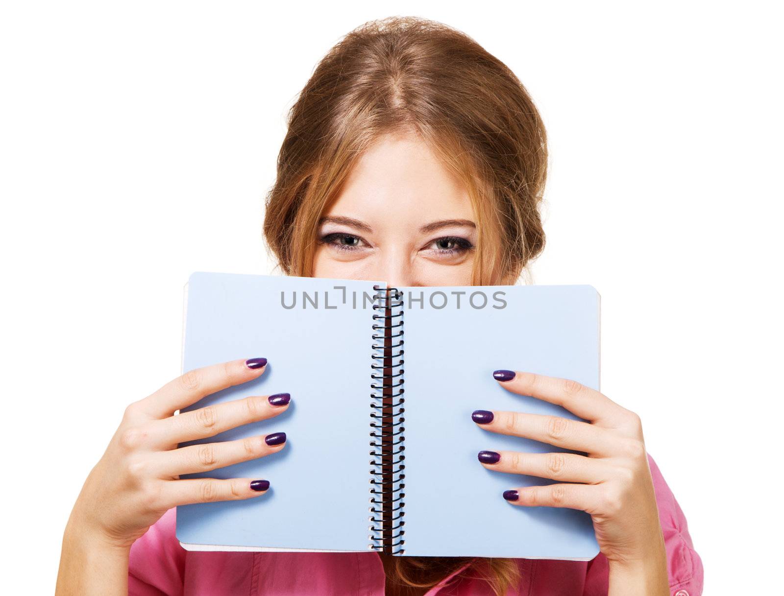 Lovely girl hiding behind notebook, white background