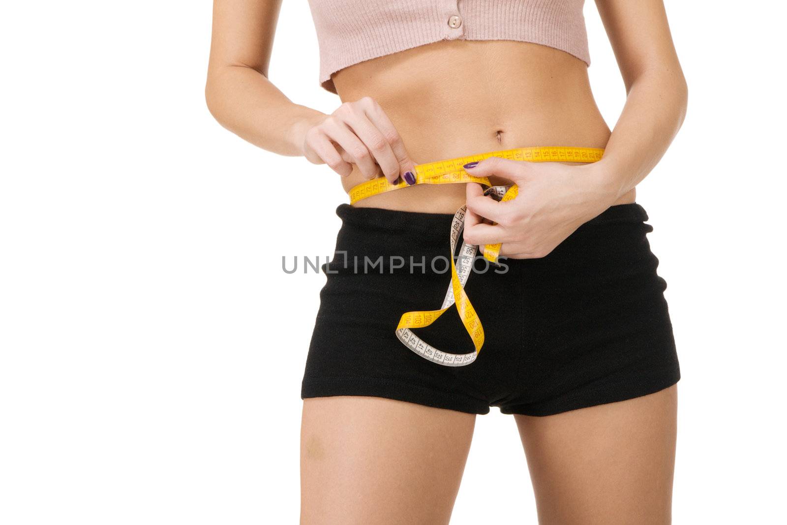 Young woman measuring her waist, white background 