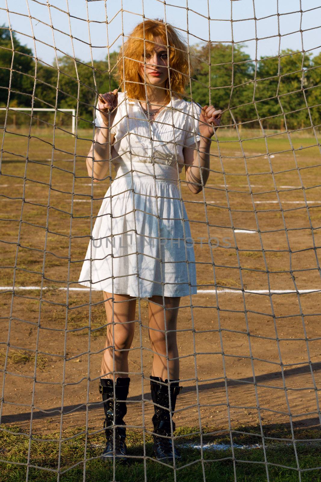 Sexy young woman at soccer gates