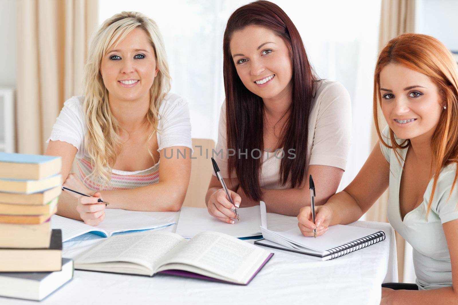 Charming Women sitting at a table learning in a kitchen