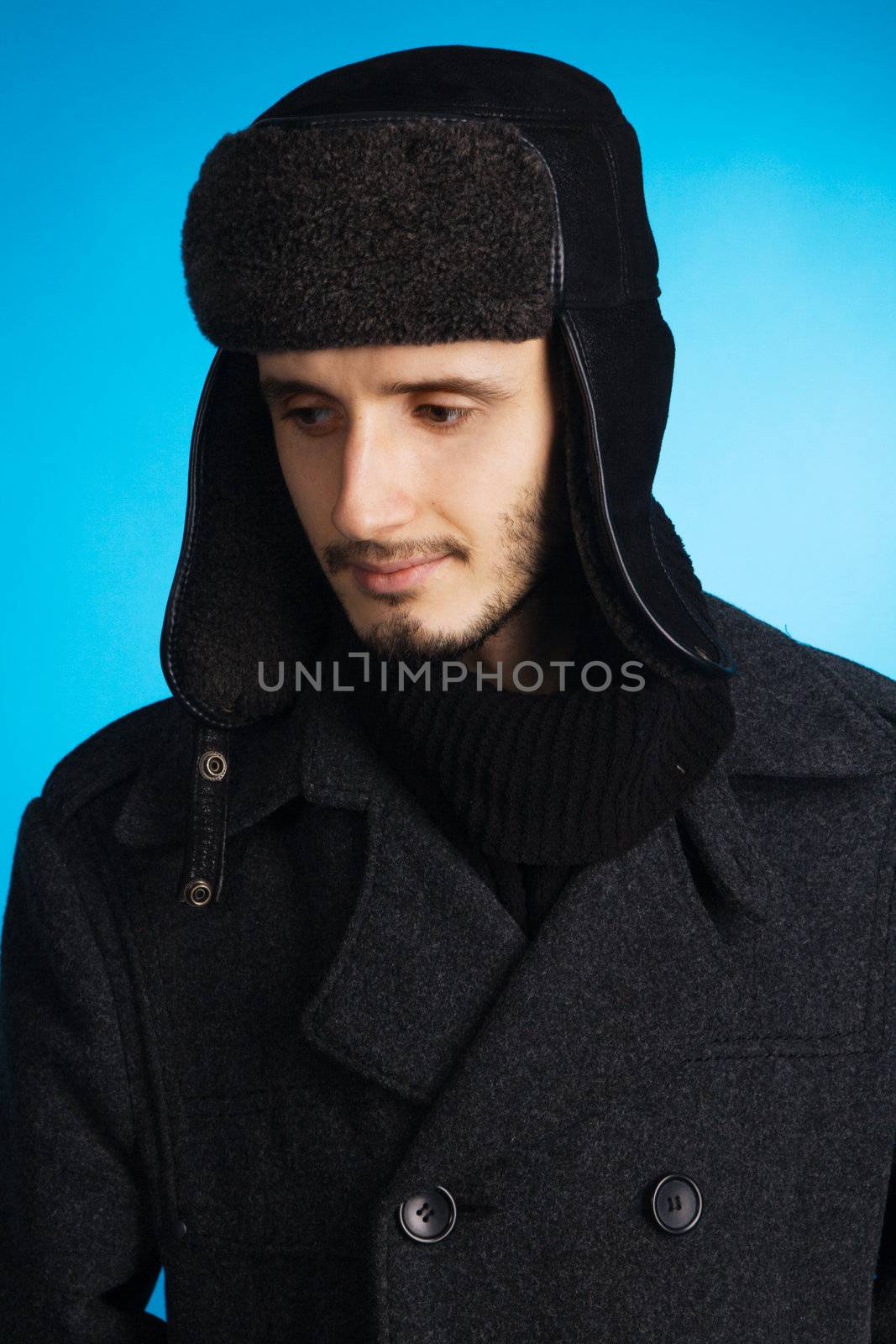 Handsome young man in winter clothing by Gdolgikh