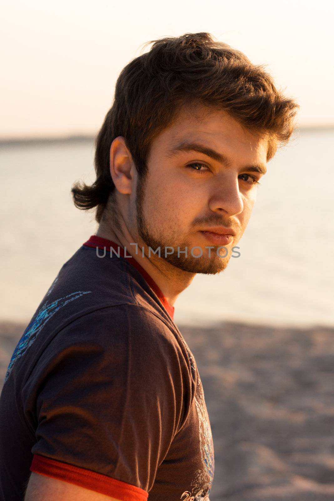 Handsome young man in sunset light