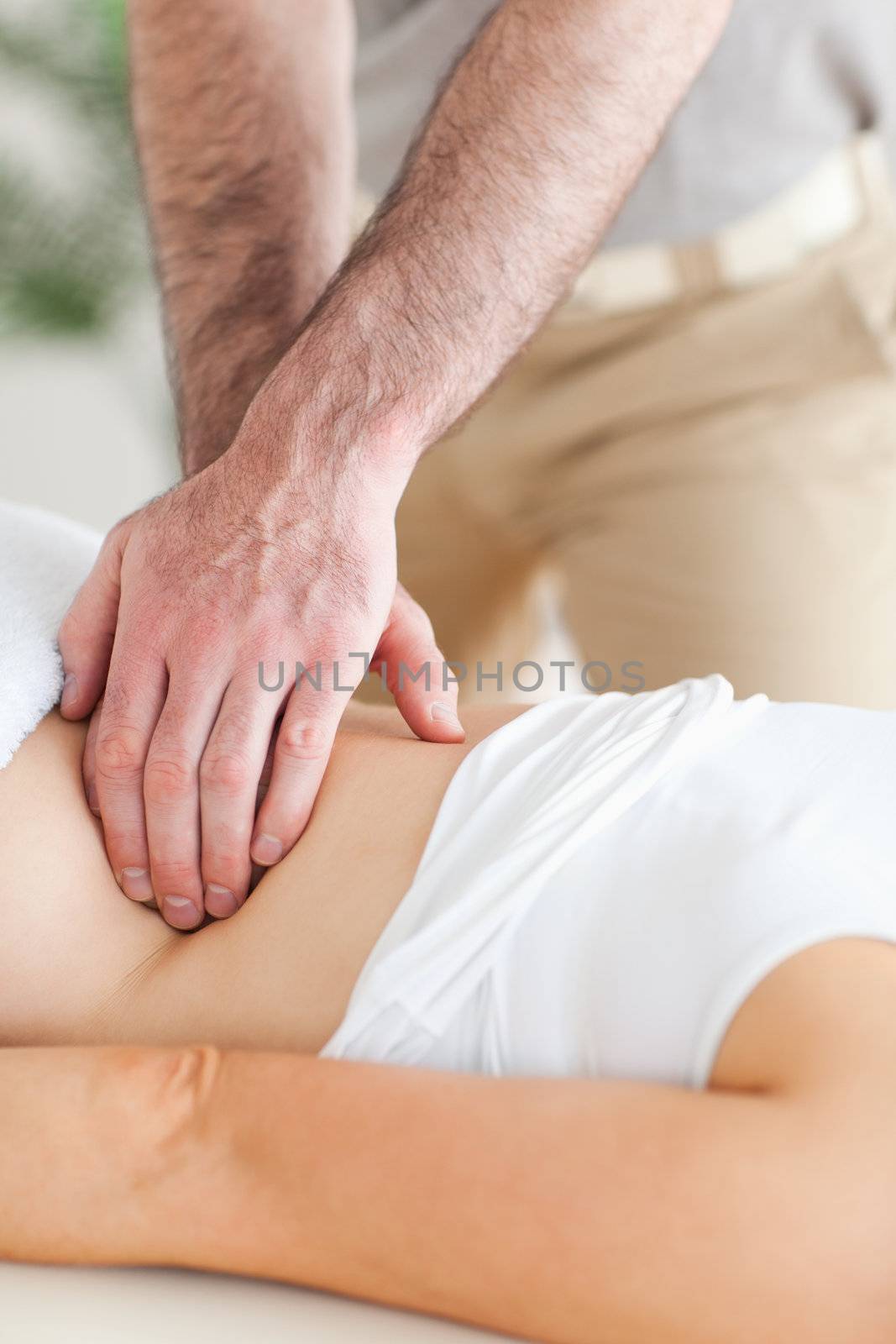 Guy massaging a person's back in a room