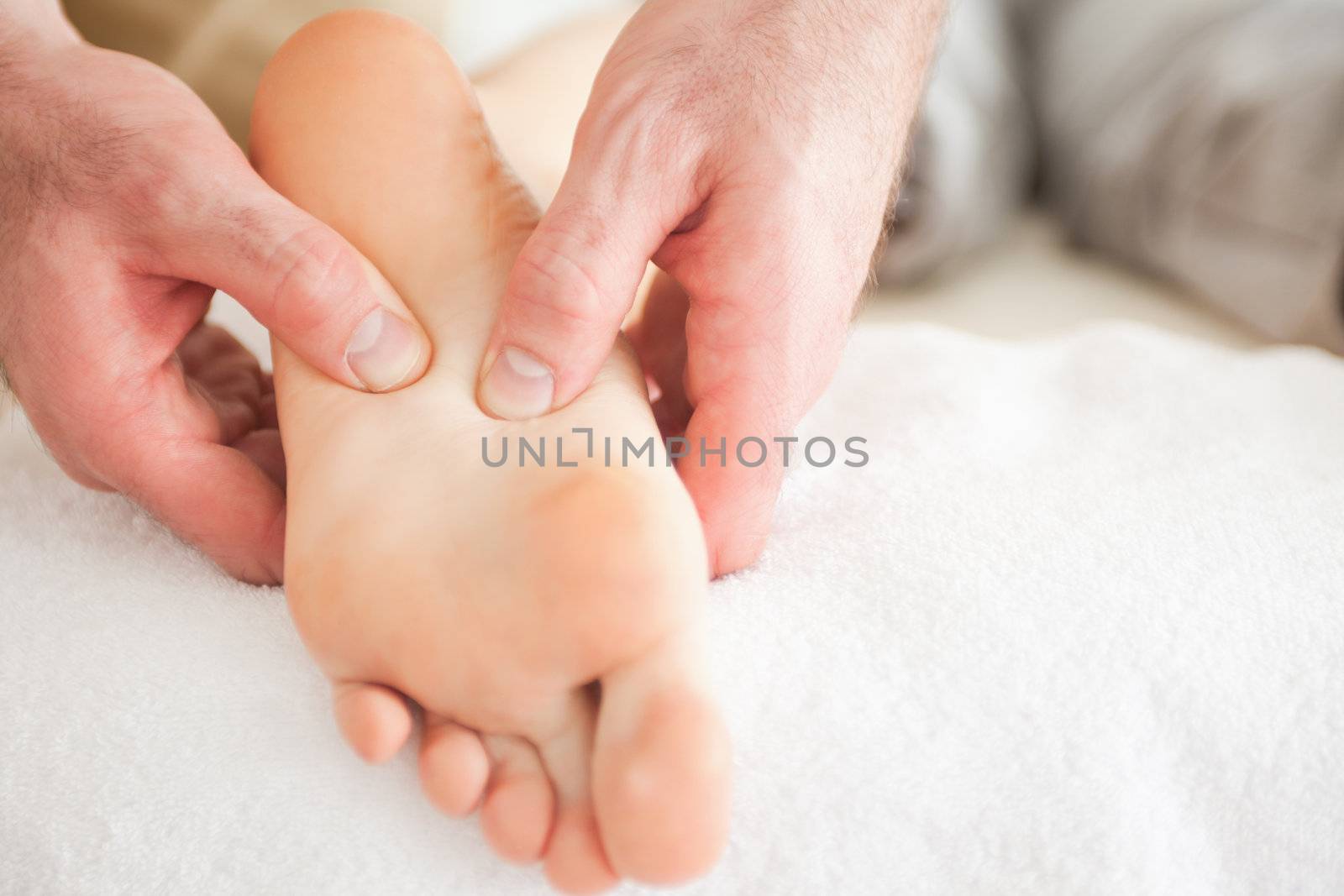 Man massaging a woman's foot in a room
