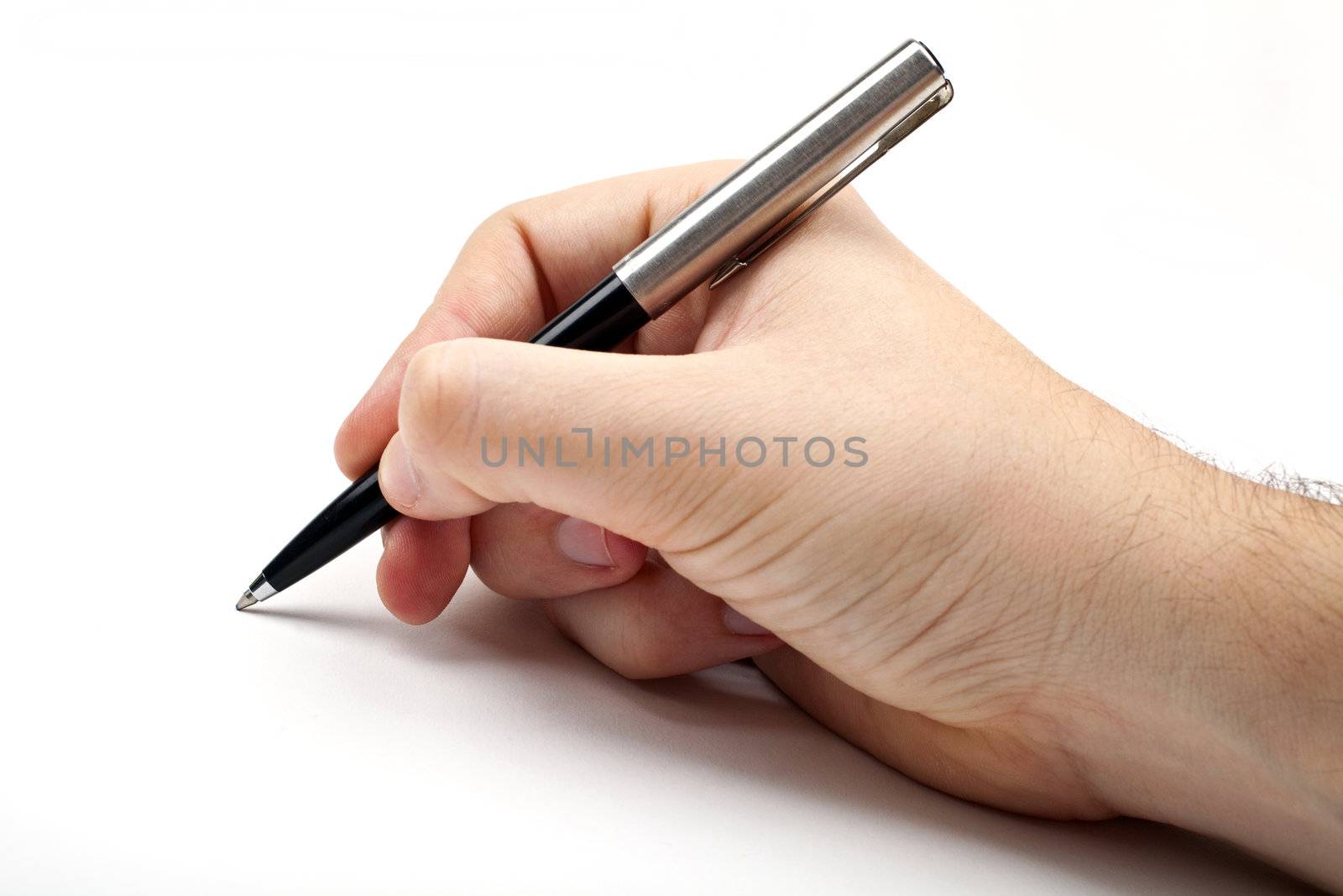 Hand holding a pen in the writing position.