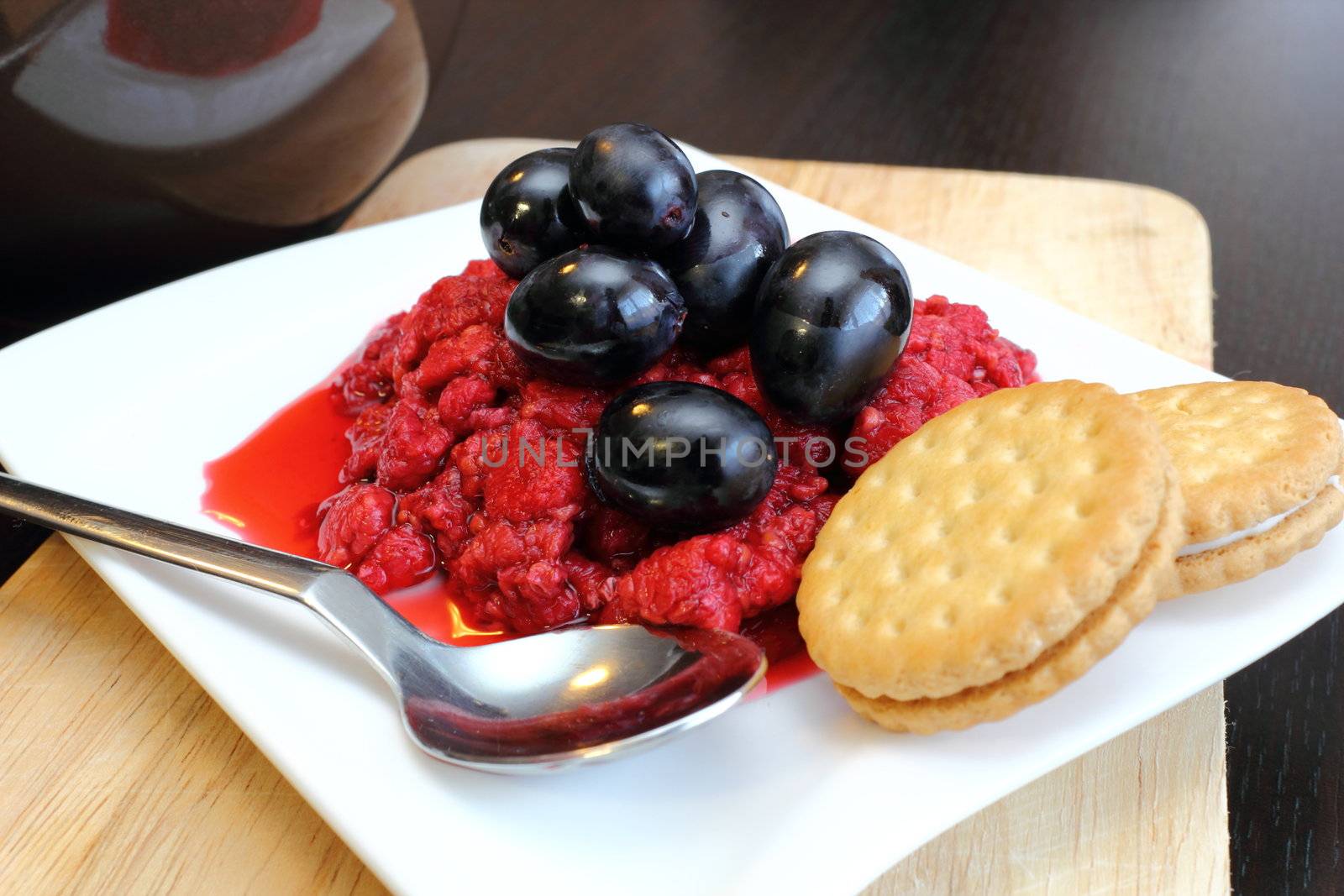 fresh morning breakfast - red grapes with wild raspberry