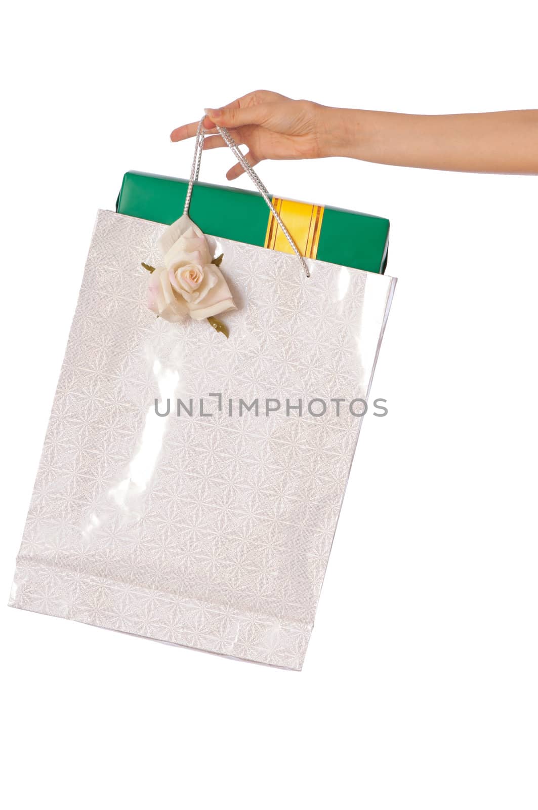 Paper bag with a green box and with a yellow ribbon from the supermarket