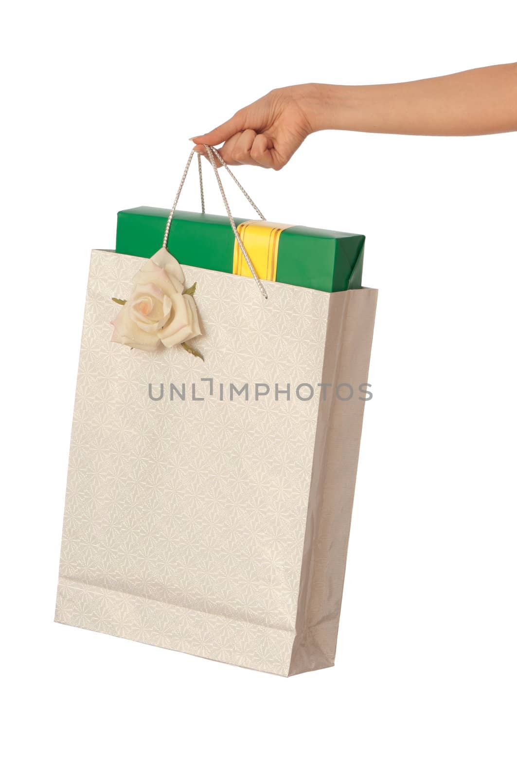 Paper bag with a green box and with a yellow ribbon from the supermarket