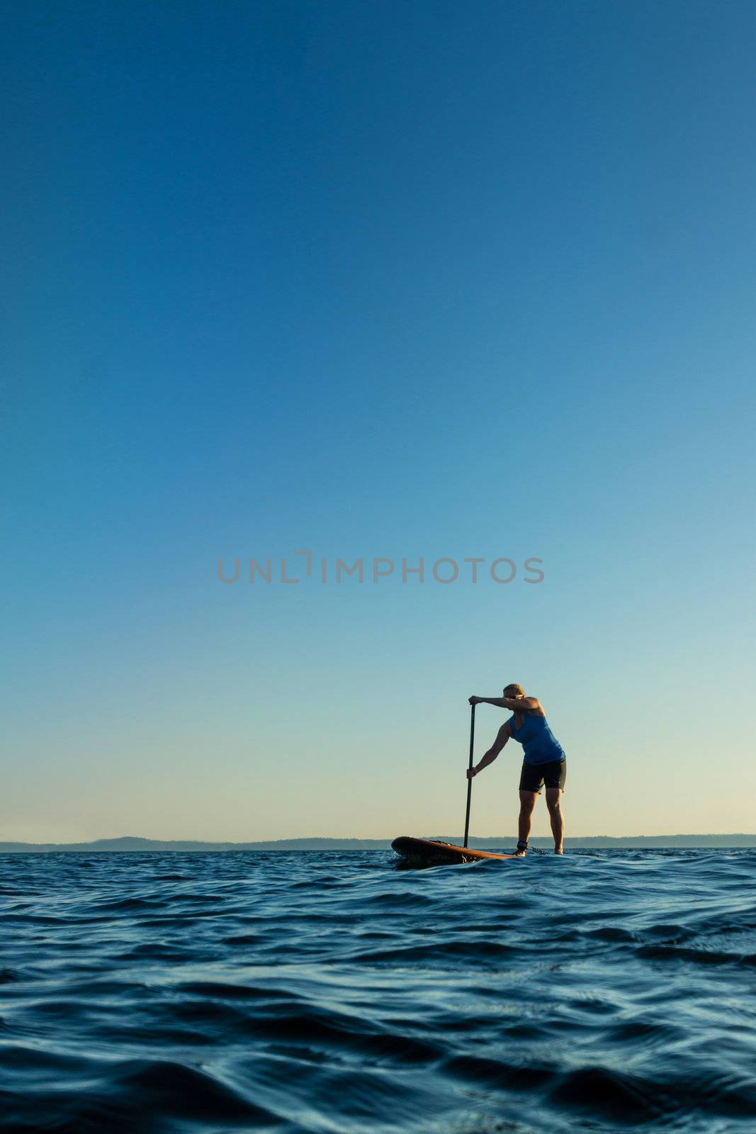 Woman paddling stand up paddle board by sketchyT