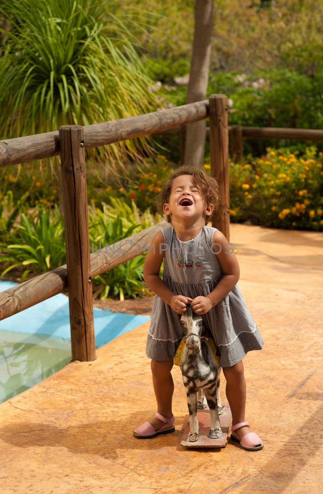 Cute Hispanic girl discovering how much fun old toys are