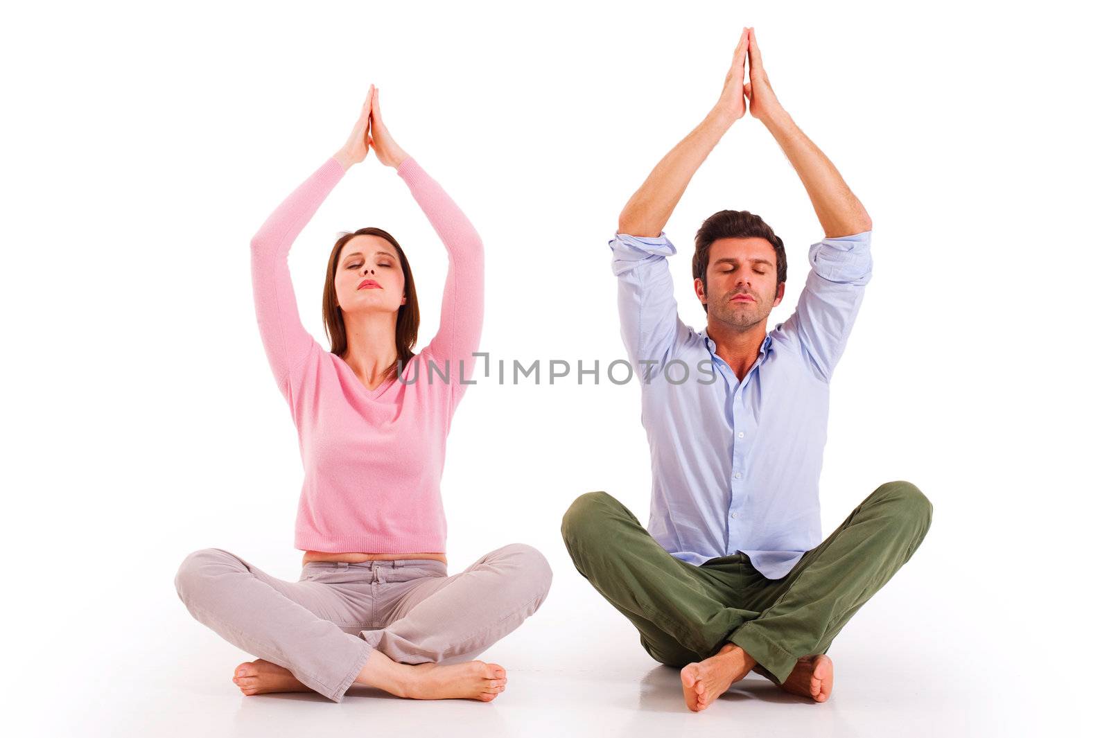 Couple practicing yoga by ambro