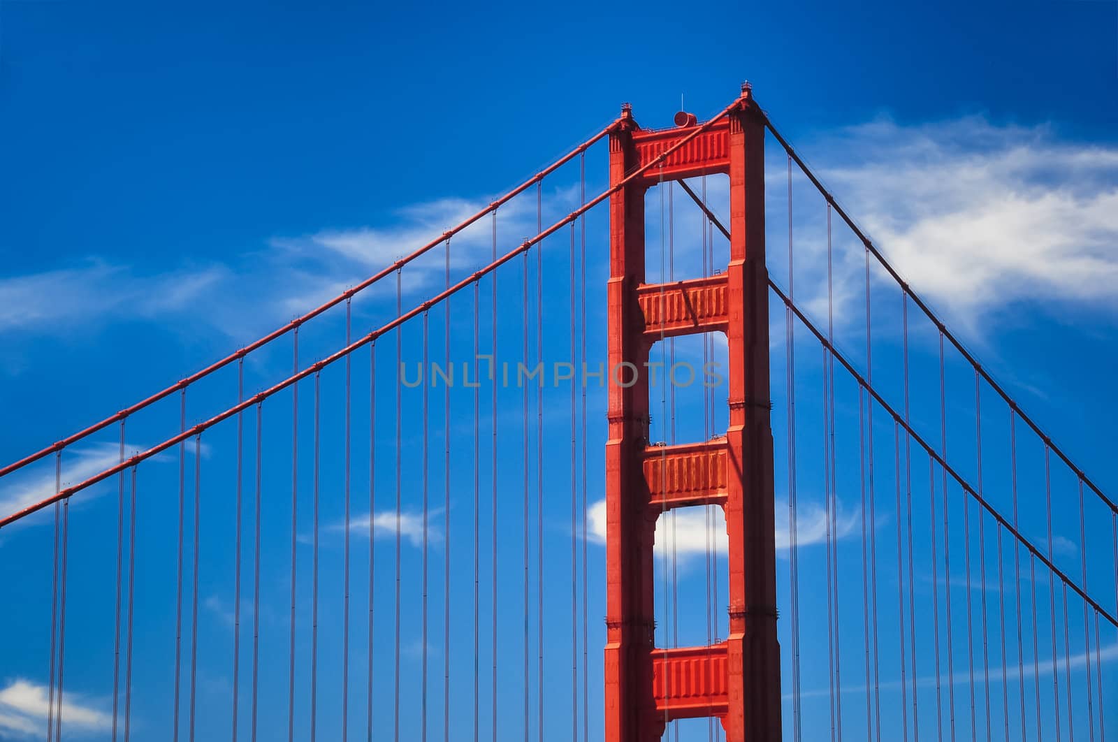 Golden Gate bridge detail with blue sky and white clouds