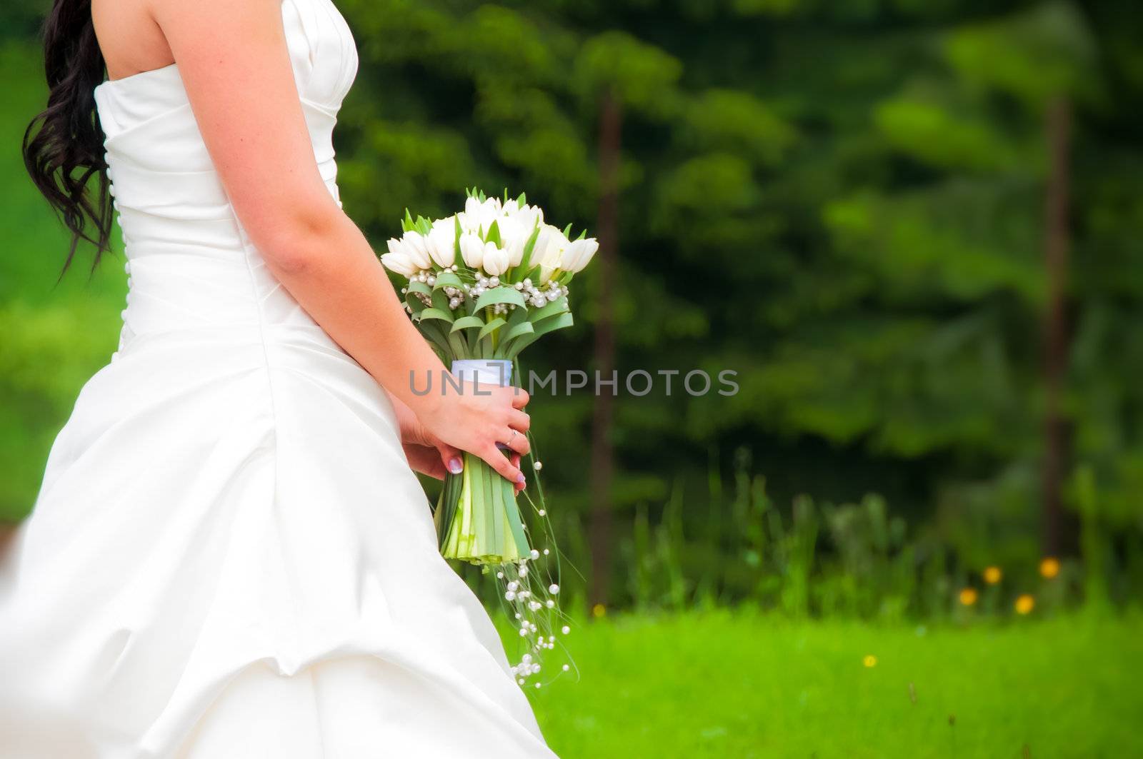 Detail of the bride in white dress with flowers by martinm303