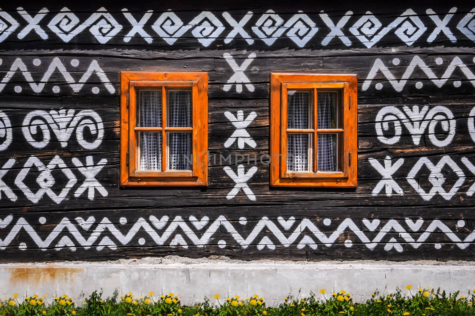 Wooden windows on wooden wall of traditional cottage, Cicmany, Slovakia