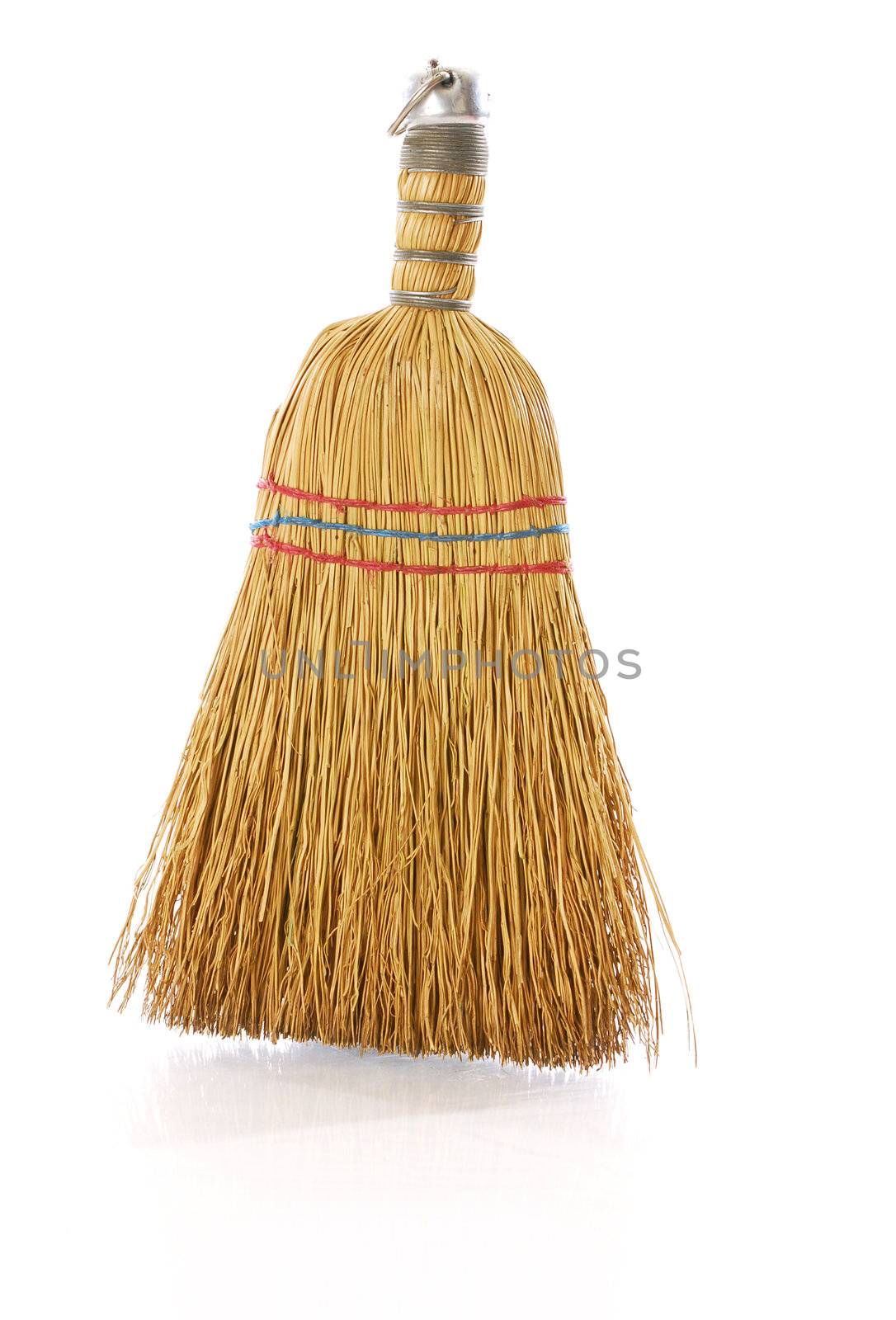 whisk broom with reflection on white background