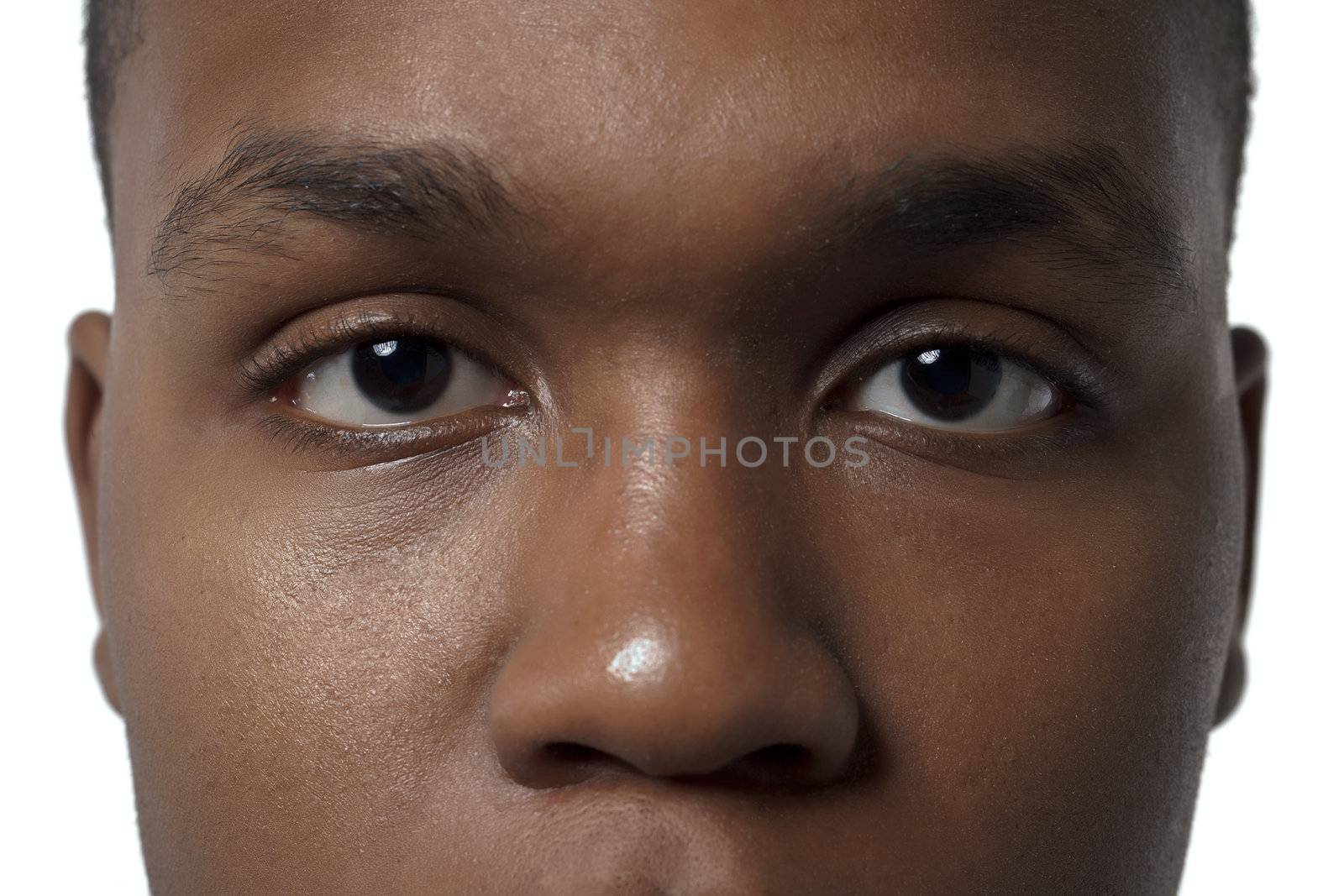 Close-up image of an African-American man's face against the white surface