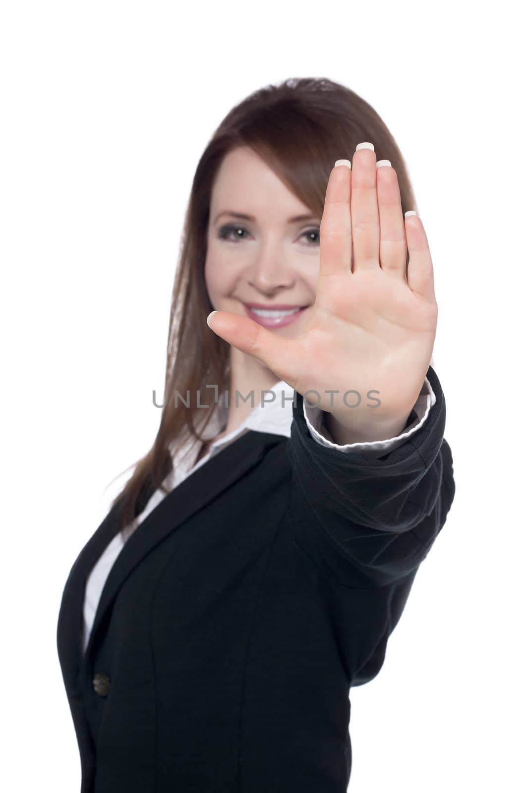 Close-up image of a happy businesswoman with a stop gesture against the white surface