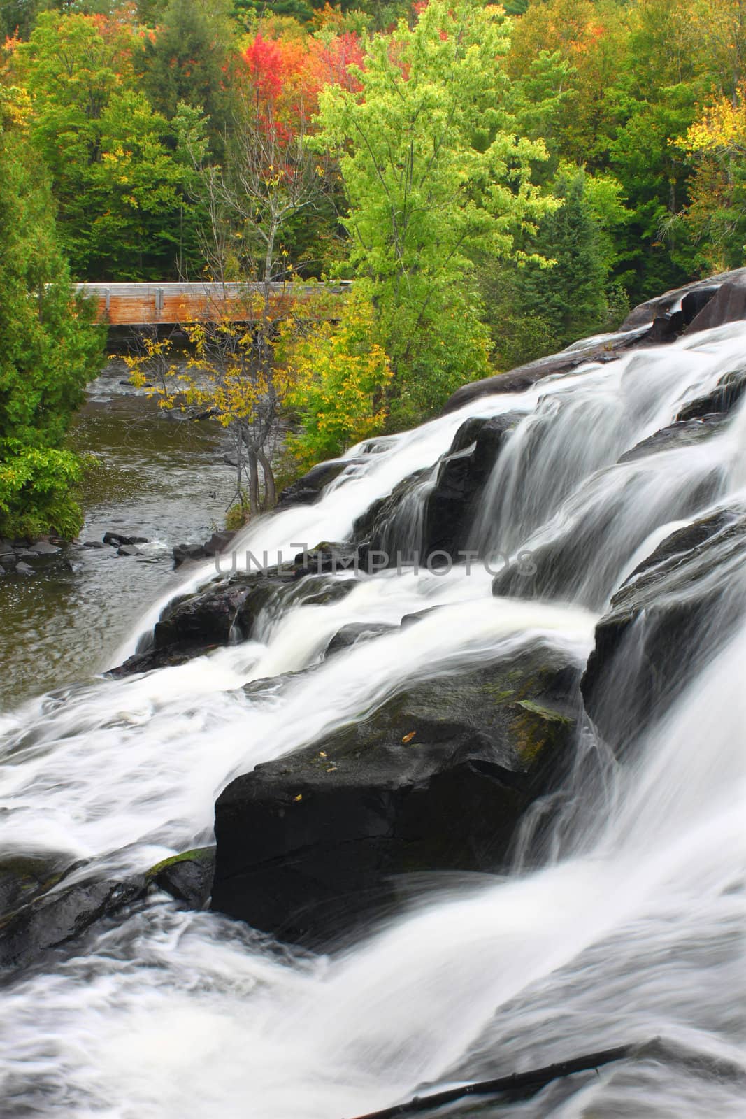 Autumn foliage surrounds the cascading waters of Bond Falls in northern Michigan.