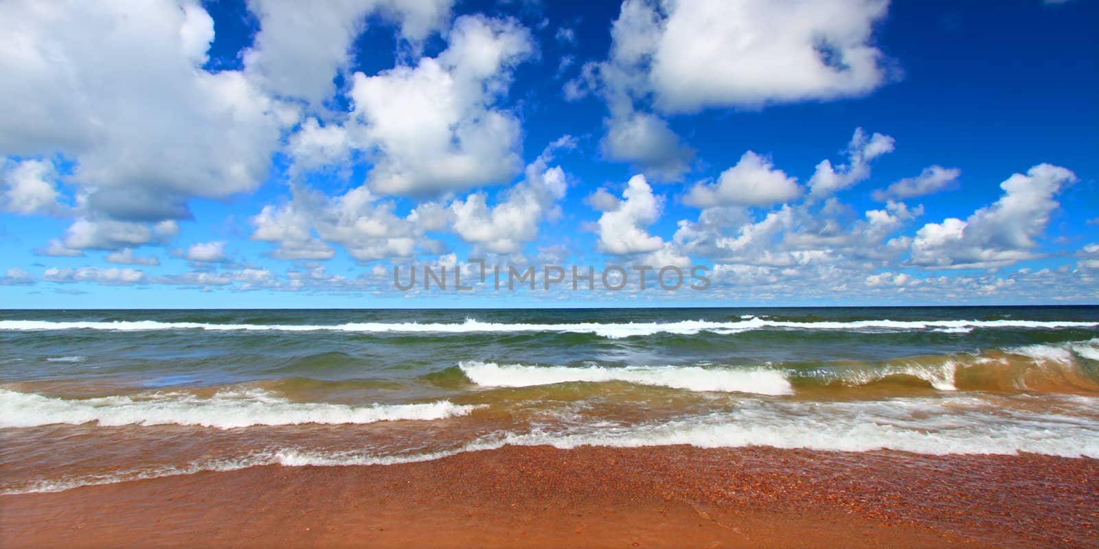 Panoramic landscape of waves crashing along the shores of Lake Superior in Michigan.