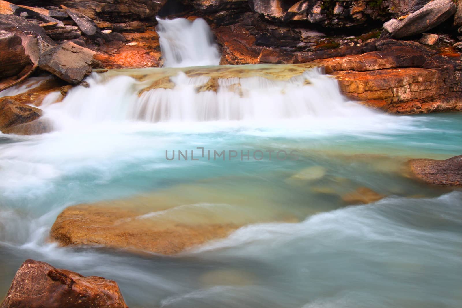 Cascades of glacial water below Twin Falls of Yoho National Park in Canada.