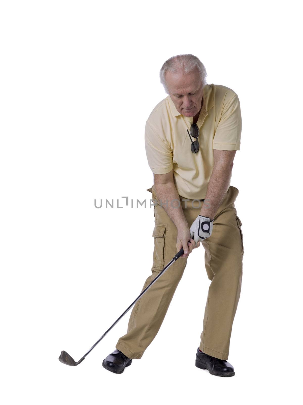 Handsome senior man playing golf