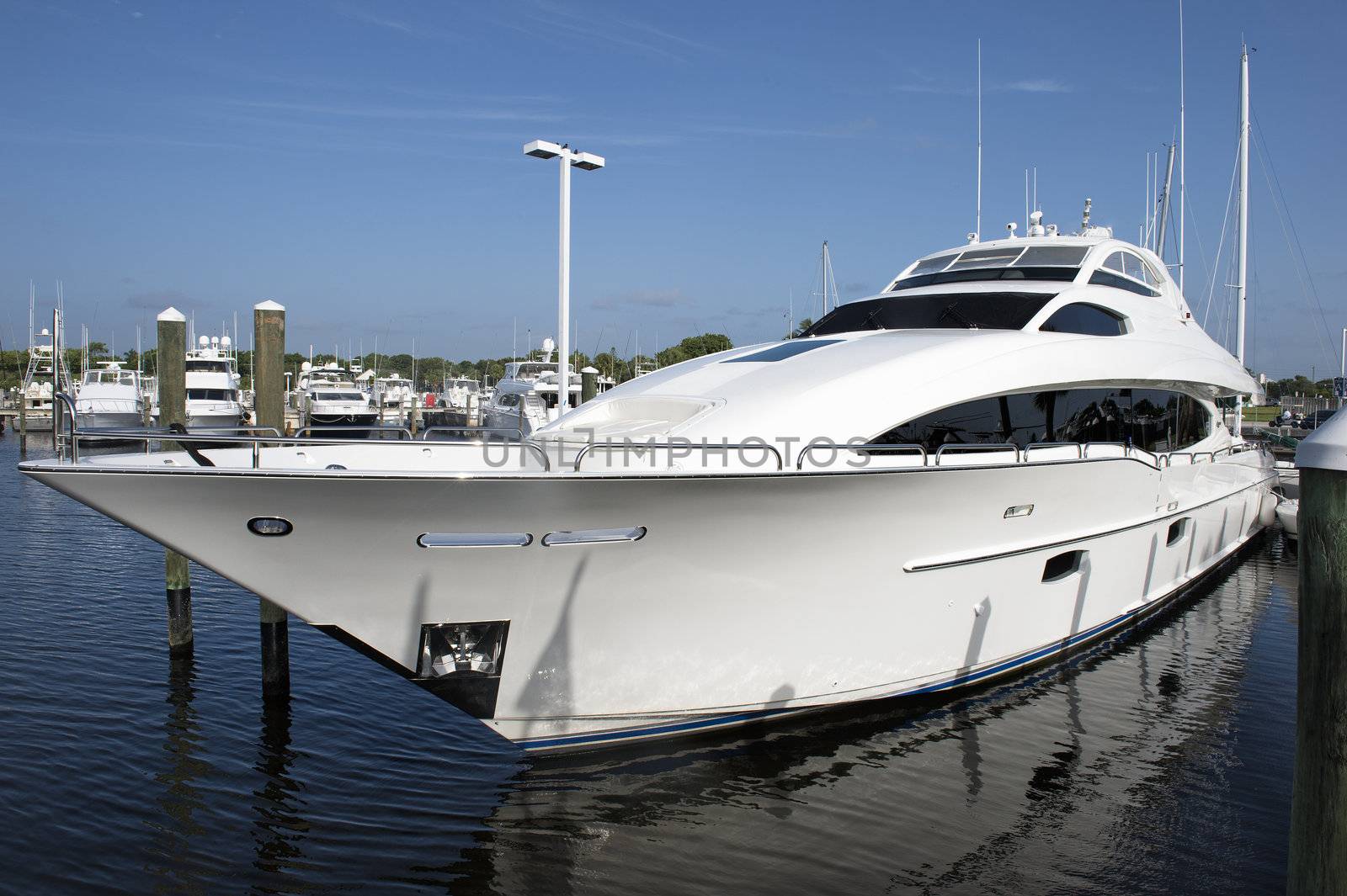 Close-up image of cruising luxurious white yacht over the calm ocean 