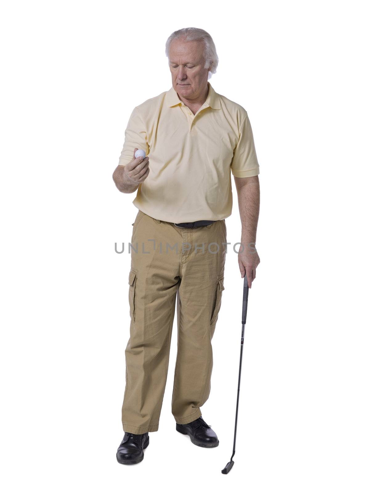 Full length portrait of old man golfer holding golf ball against white background