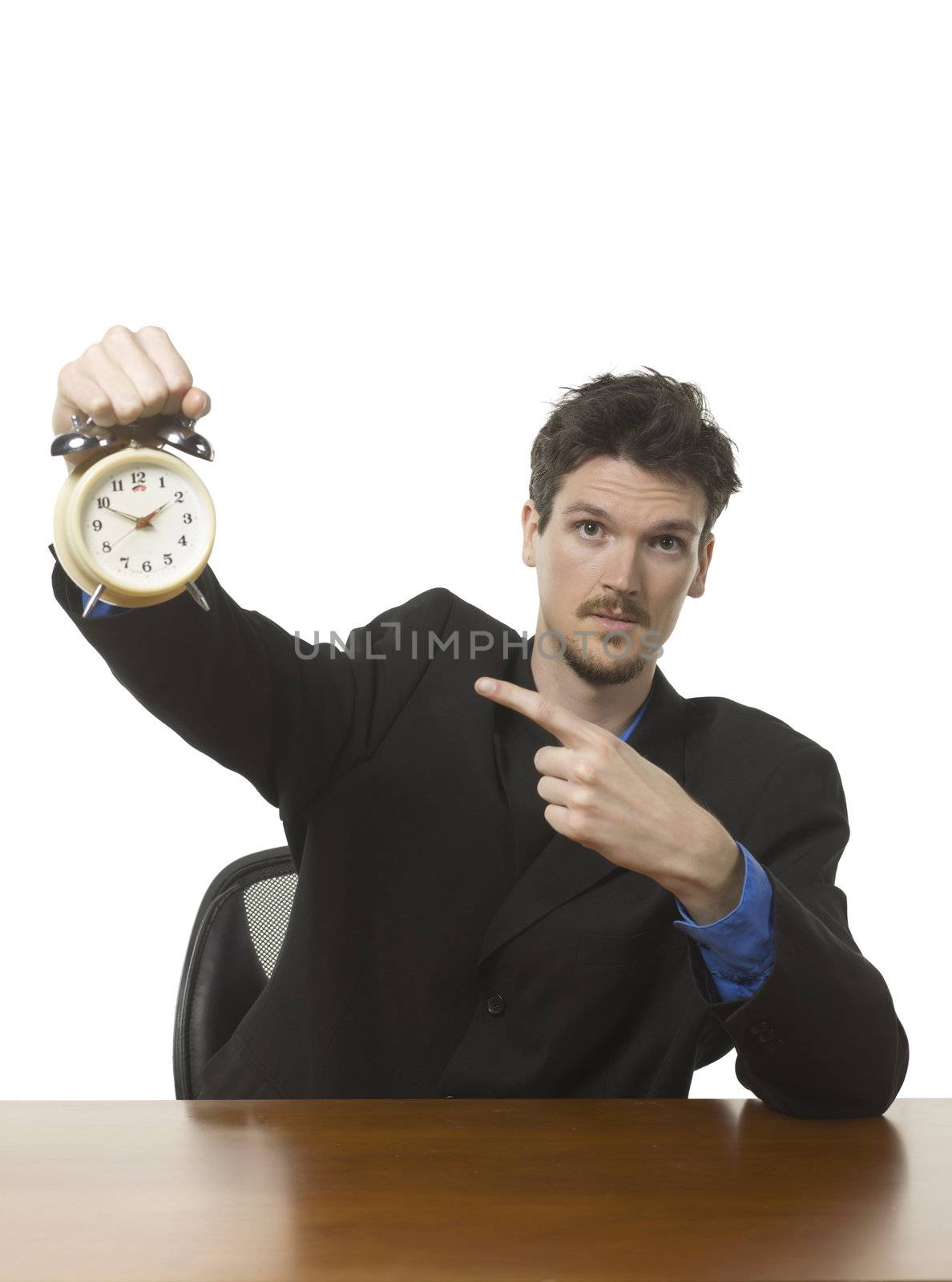 Caucasian businessman showing an alarm clock