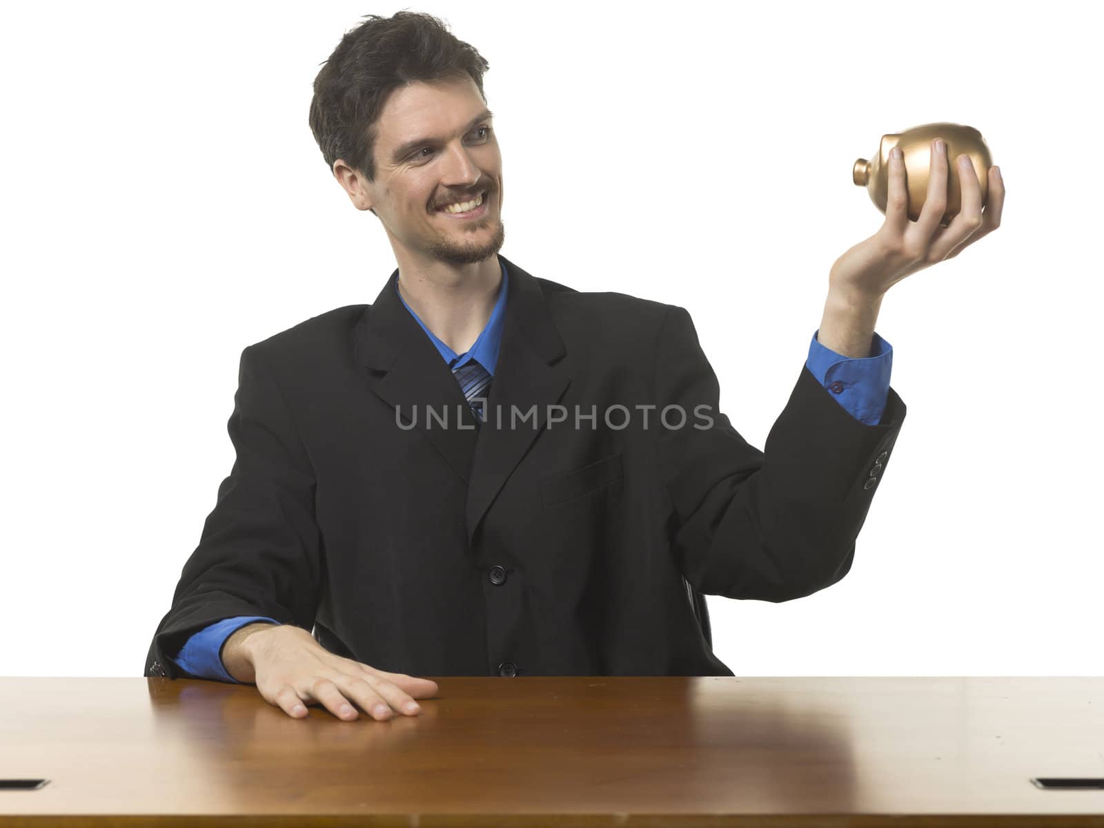 Portrait of happy businessman holding piggy bank against white background