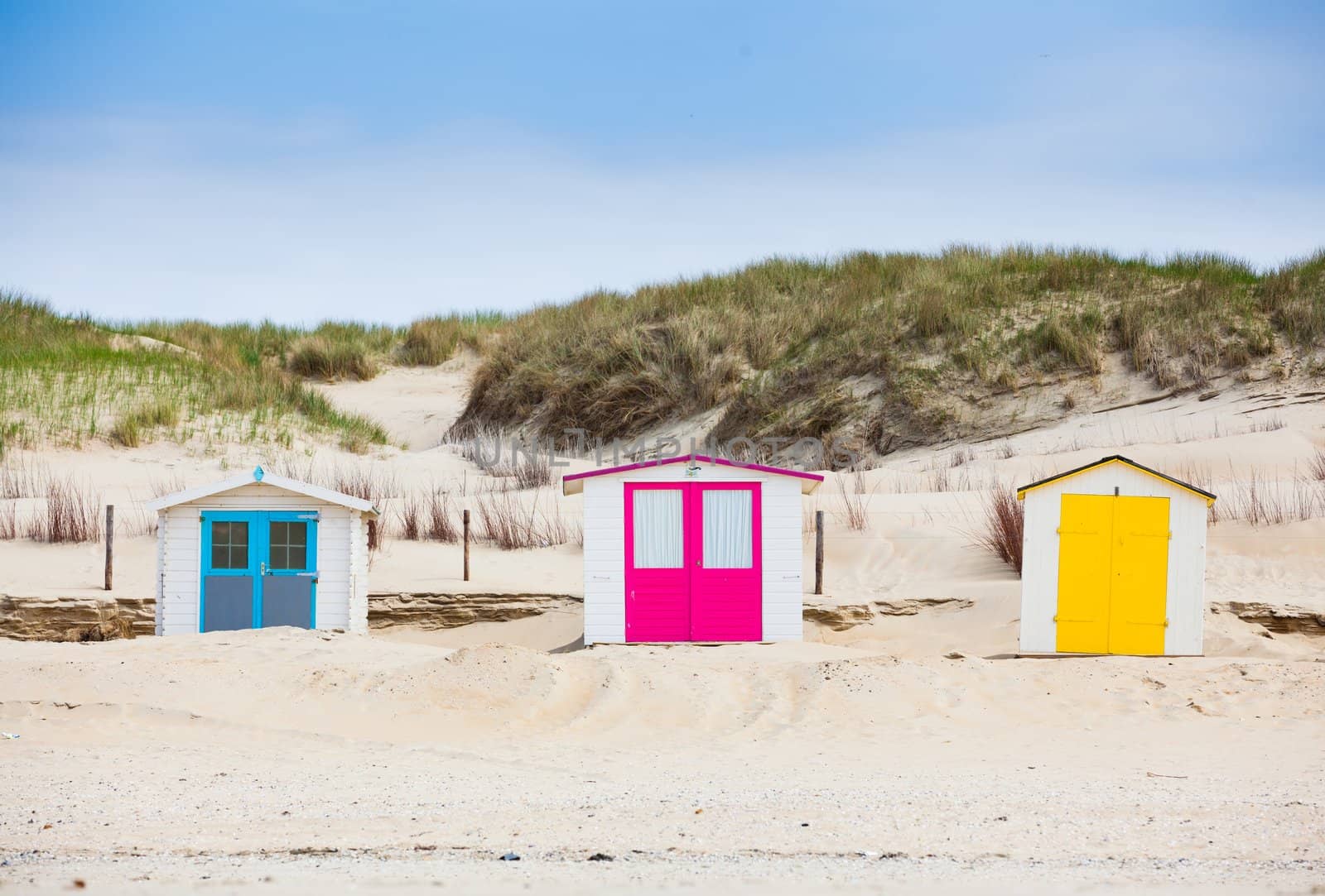 Dutch houses on the beach with blue sky. Texel, Holland