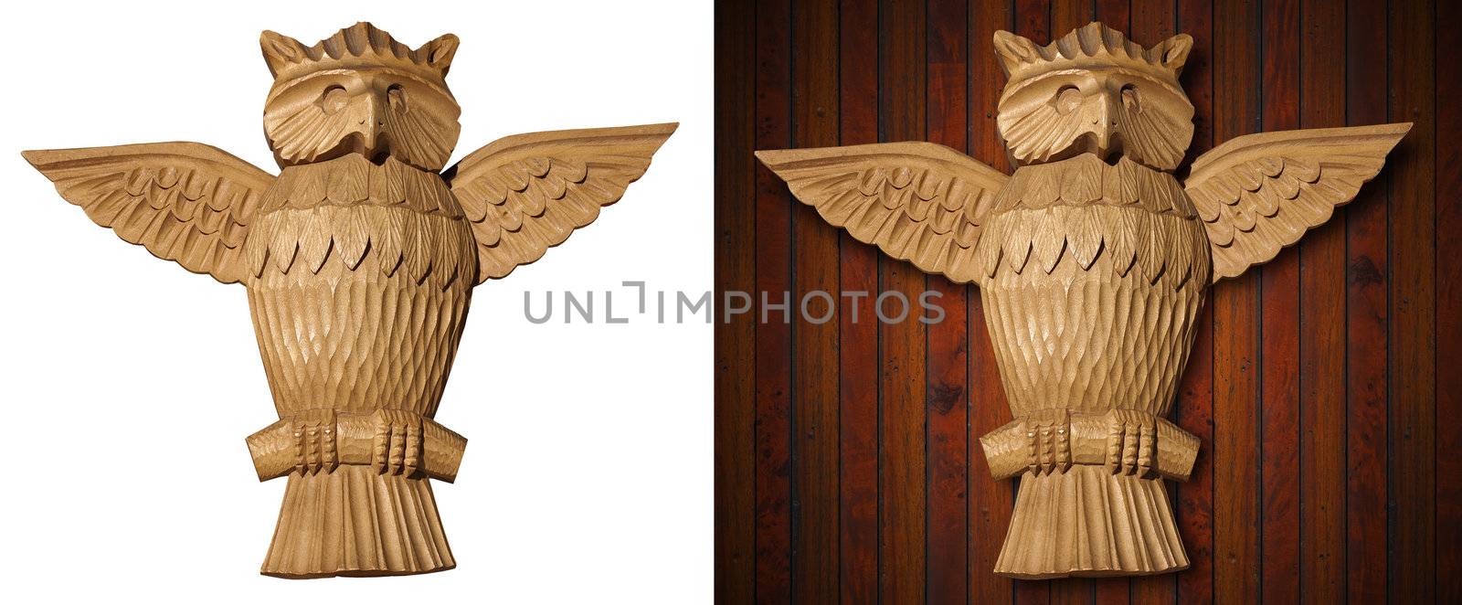 Old wooden carved owl isolated on white and wooden background