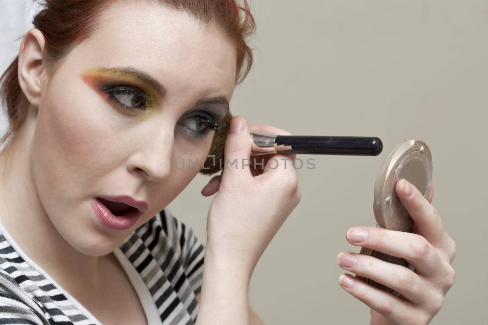 a woman applying eyeshadow by kozzi