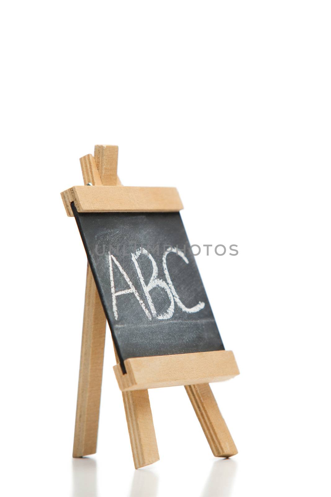 Angled chalkboard with the letters abc written on it isolated against a white background