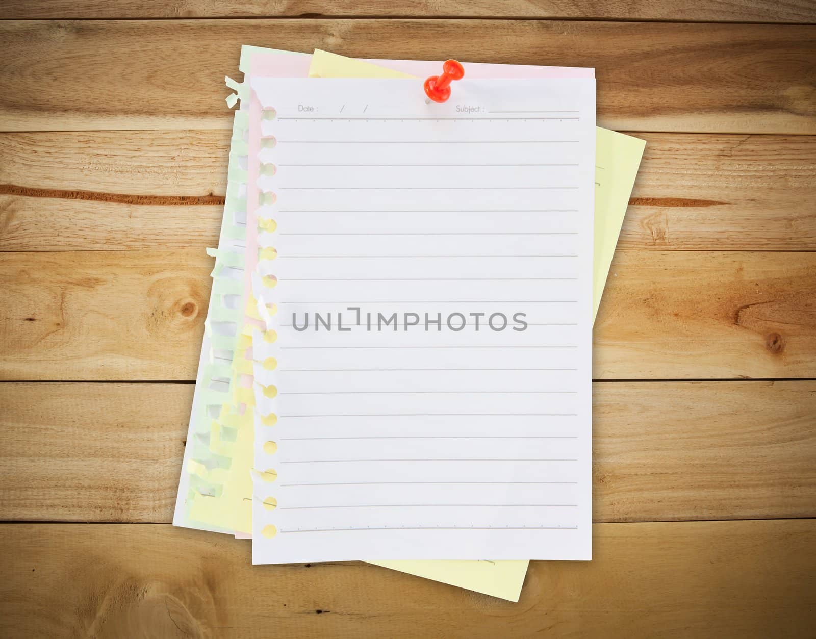 paper sheet and red pin on wood texture background