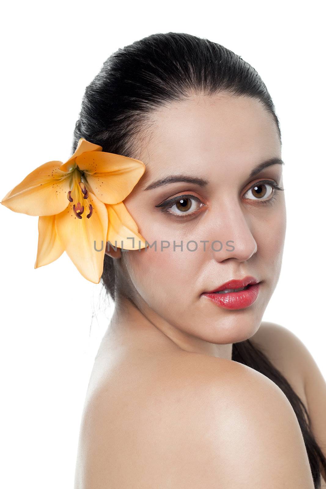 Close-up image of a beautiful lady with an orange flower on ear 