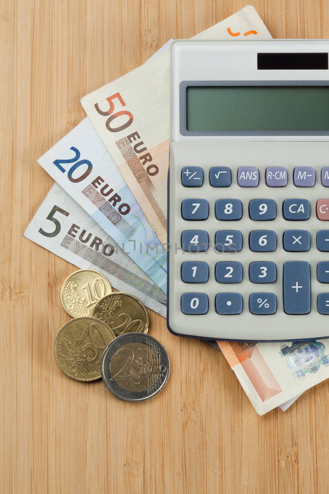 Money and pocket calculator on a desk