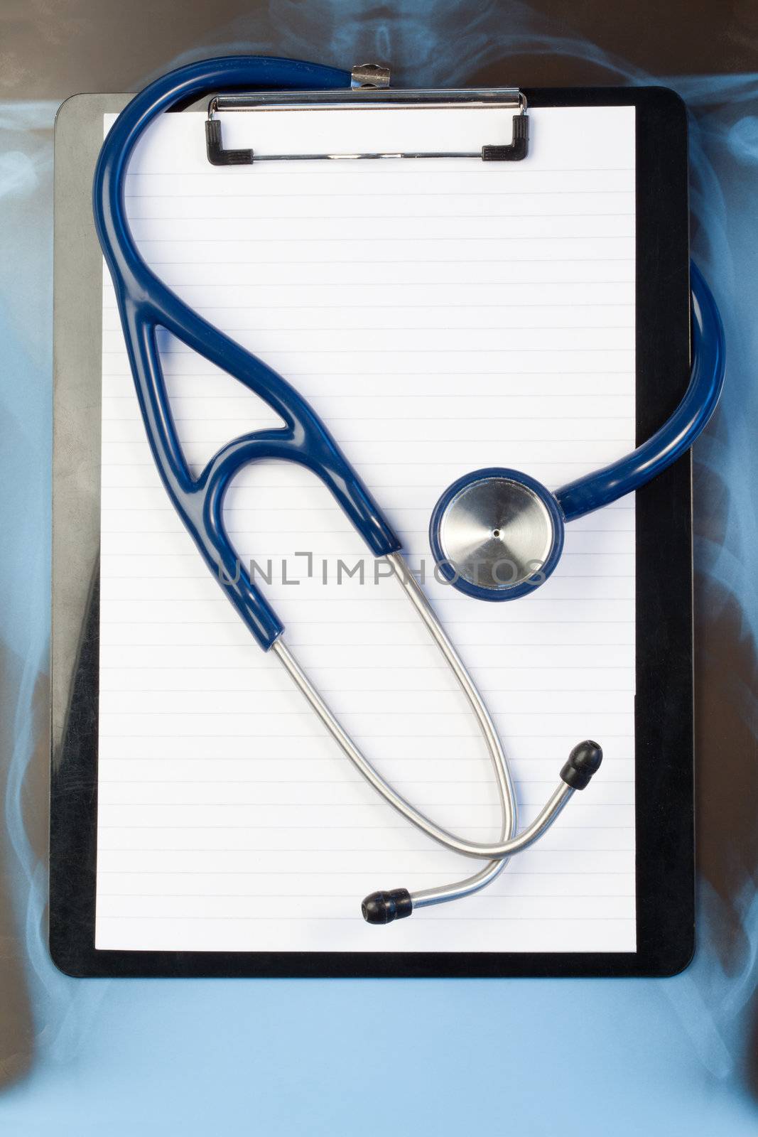 Note pad and stethoscope on a blue and dark background