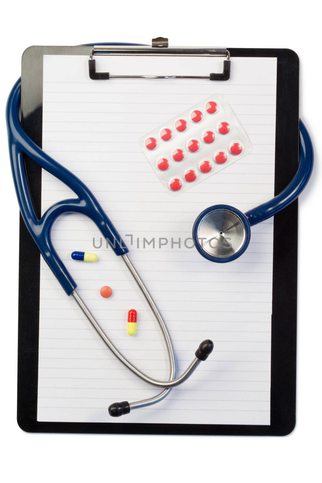 Note pad and stethoscope with color pills and blister strip on a white background