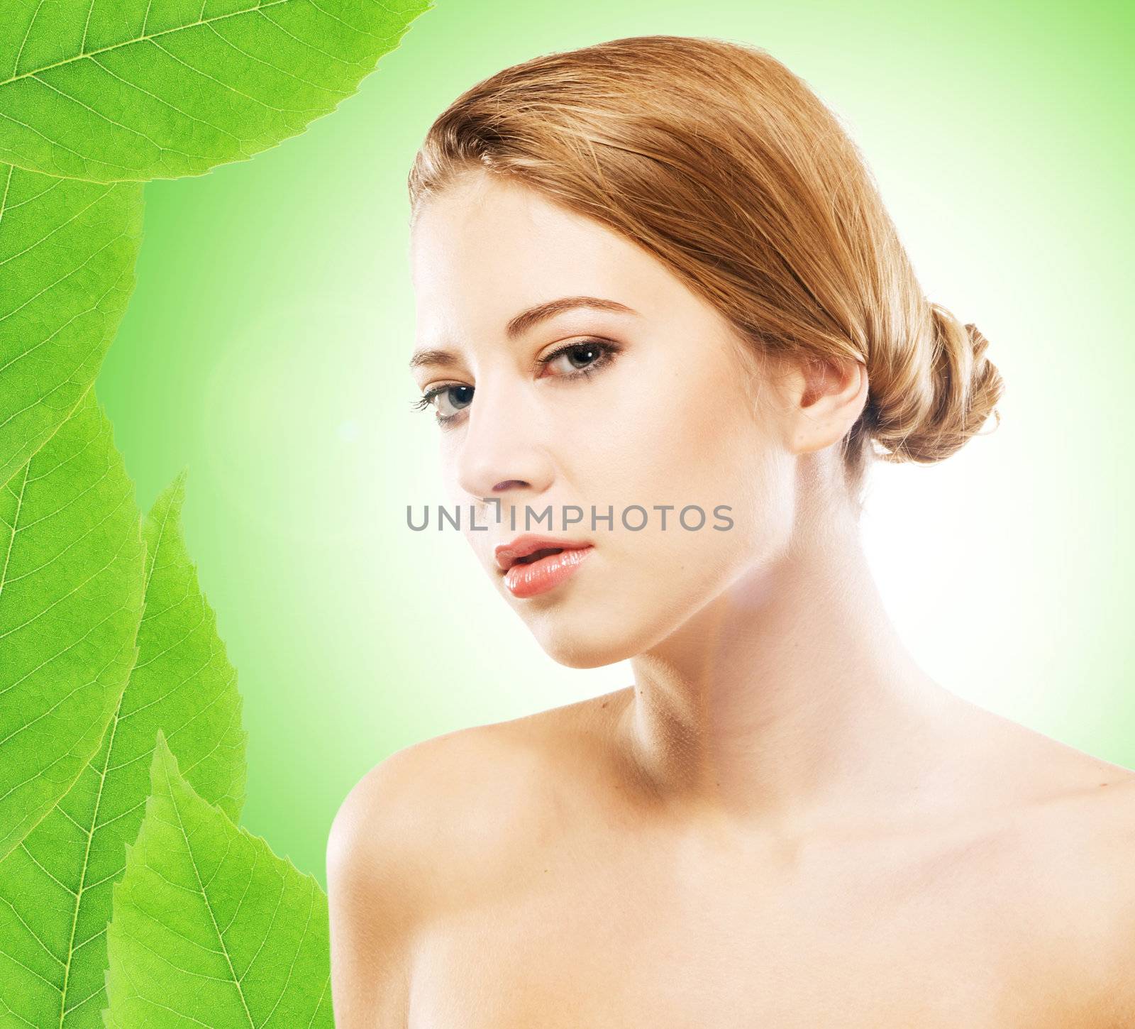 Young beautiful woman over green natural background