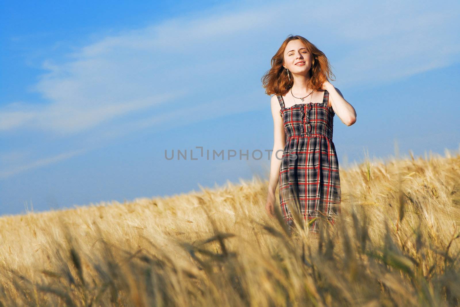 Beautfiul woman in checkered dress in a field by Gdolgikh