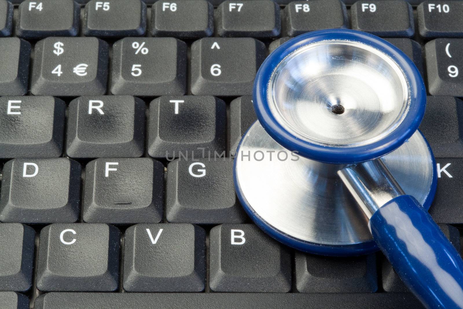 Blue stethoscope on keyboard