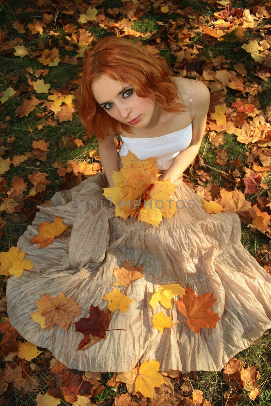 Romantic photo of a young woman in yellow leaves