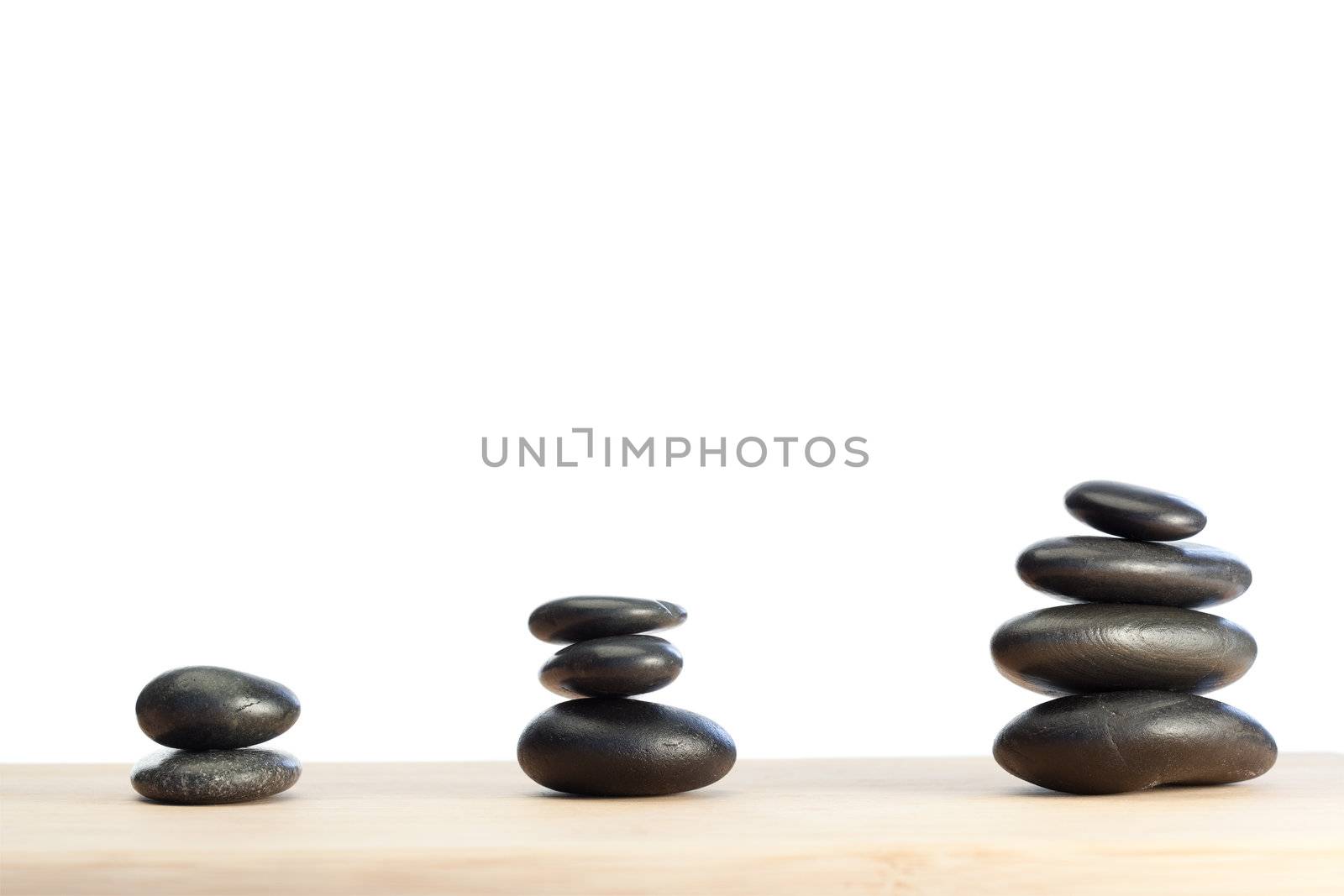 Spaced out and piled up pebbles on a white and brown background
