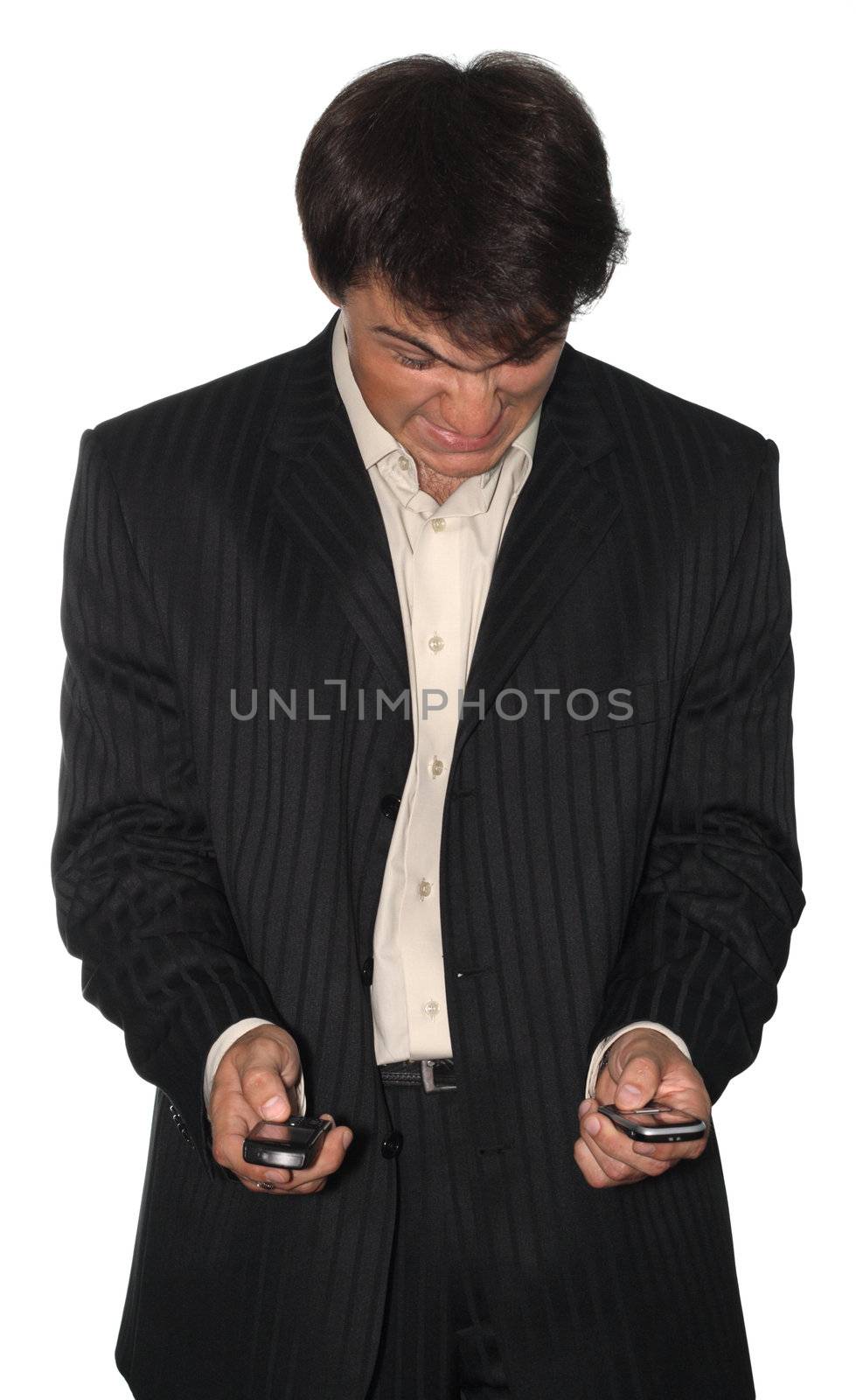 Angry businessman holding two mobile phones, isolated on white background