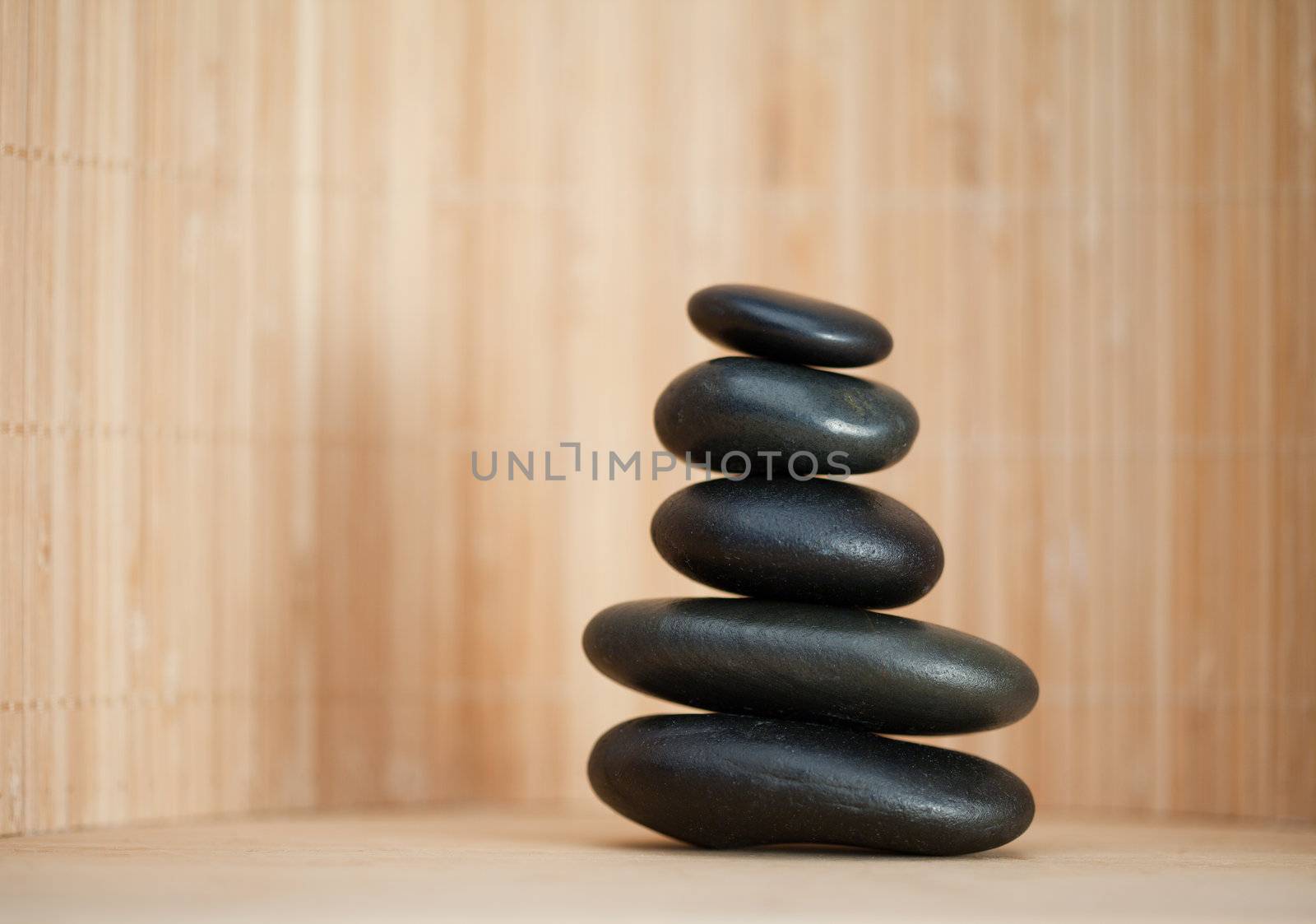 Several piled up pebbles on a brown background
