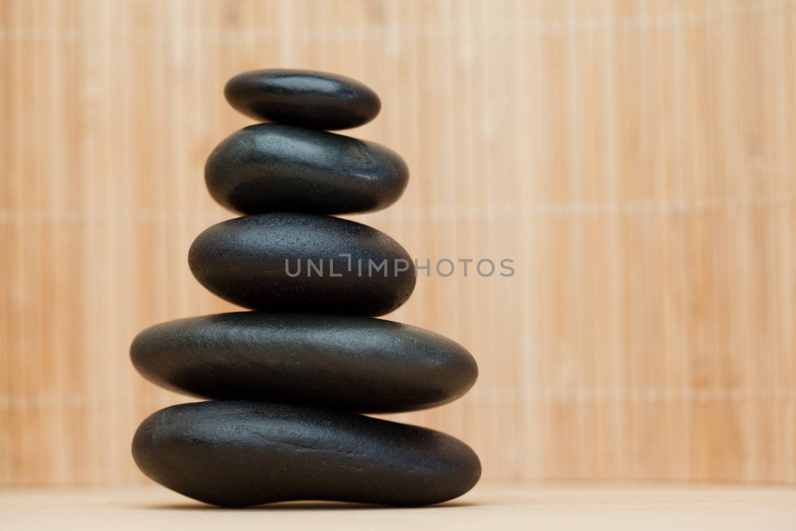 Many piled up pebbles on a brown background