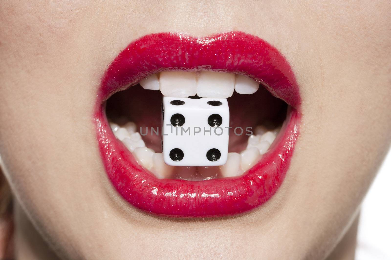 Close-up image of a woman's red lips with gambling dice 